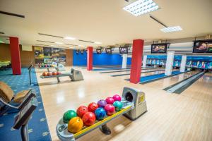 a bowling alley with pins and balls on the lanes at Kopala Tskneti Hotel in Tsqnetʼi