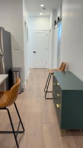 a kitchen with a green counter and two chairs at Soho House - 20 Min to NYC - Breakfast Included- A in Jersey City +11 photos