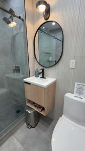 a bathroom with a sink and a shower and a mirror at Soho House - 20 Min to NYC - Breakfast Included- A in Jersey City