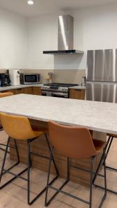 a kitchen with a table and two chairs at Soho House - 20 Min to NYC - Breakfast Included- A in Jersey City