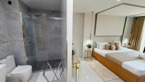 a bedroom with a king sized bed and a shower at Vista Mar Suites in Praia