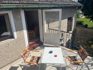 a patio with a table and chairs on a balcony at Pure Nostalgie am Scharmützelsee in Wendisch Rietz