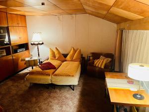 a bedroom with a bed and a couch in it at Pure Nostalgie am Scharmützelsee in Wendisch Rietz +3 photos