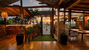 a patio with a table and potted plants at Casita Madame - Frente al Mar con Desayuno Gourmet in Puerto López