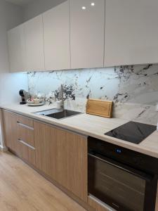 a kitchen with a sink and a counter top at Moon&Mori in Augustów