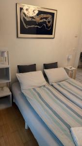 a bedroom with two beds and a picture on the wall at Gemütliche Zimmer mit eigenem Badezimmer an guter Lage in Bern