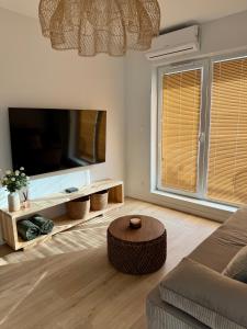 a living room with a large flat screen tv at Moon&Mori in Augustów