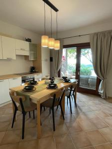a kitchen with a table and chairs in a room at Sea Sky Villa with private pool in Costa Paradiso