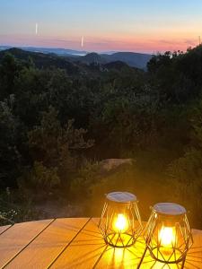 two lights sitting on top of a table with a view at Sea Sky Villa with private pool in Costa Paradiso