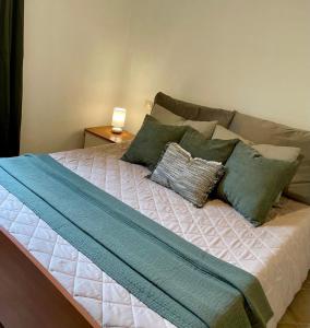 a bed with pillows on it in a bedroom at Sea Sky Villa with private pool in Costa Paradiso