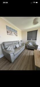 a living room with a couch and a table at Saddlebrook 156 in Leysdown-on-Sea