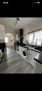 a kitchen with a washing machine and a sink at Saddlebrook 156 in Leysdown-on-Sea