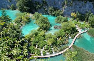 an aerial view of a river with trees and a bridge at Rooms & Glamping Lana Haus in Ličko Petrovo Selo