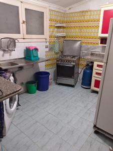 a kitchen with a stove and a tiled floor at Diamond Beach In Marina, Egyptw in Dawwār Abū Maḩrūs