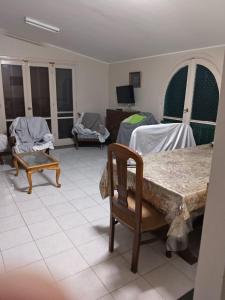 a living room with a table and chairs at Diamond Beach In Marina, Egyptw in Dawwār Abū Maḩrūs