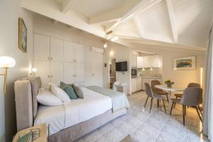 a bedroom with a bed and a table and chairs at Argostοli Bay Apartments in Argostoli