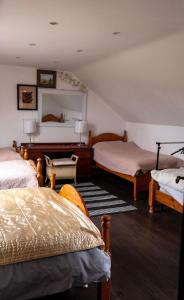 a bedroom with two beds and a mirror at Bella Vista in Carlingford