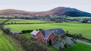an aerial view of a red house in a field at Bella Vista in Carlingford