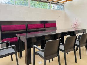 a dining room with a black table and chairs at Abi's Place Benin in Benin City