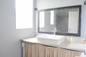 a bathroom with a white sink and a mirror at Le refuge, 4 personnes in Envermeu +29 photos