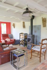 a living room with a couch and a fireplace at Le refuge, 4 personnes in Envermeu