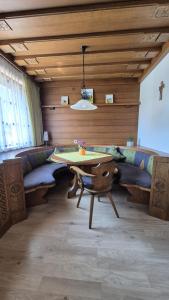 a dining room with a table and a couch at Ferienwohnung Sonnweber in Stanzach