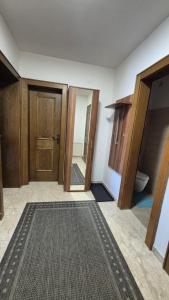 an empty room with a door and a rug at Ferienwohnung Sonnweber in Stanzach