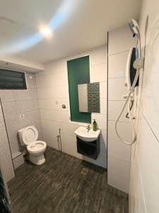 a bathroom with a toilet and a sink at 7 Hotel in Juru +54 photos