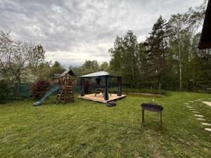 a playground with a slide and a play structure at Igor House in Jūrmala