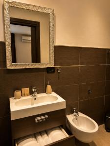 a bathroom with a sink and a mirror at B&B La Bouganville in Alghero