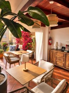 a restaurant with tables and chairs and plants at B&B La Bouganville in Alghero +13 photos