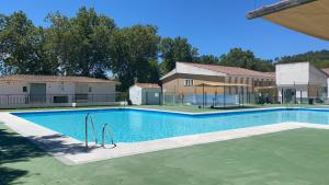 a large swimming pool with a playground in a building at Alojamiento El Monasterio in Almonaster la Real