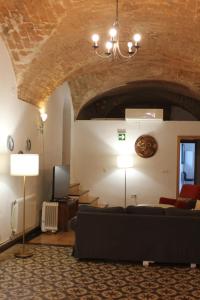 a living room with a couch and a brick wall at Alojamiento El Monasterio in Almonaster la Real +73 photos