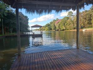 a dock on a river with a boat in the water at Cabañas Gonga - Posada turistica in Ciudad del Este