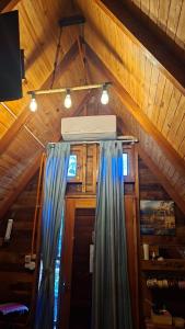 a room with awning and curtains in a cabin at Cabañas Gonga - Posada turistica in Ciudad del Este