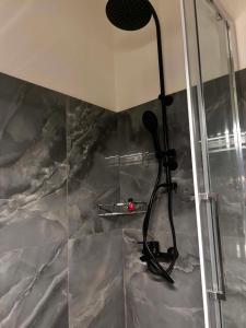 a shower with a shower head in a bathroom at Grand view resort in Argostoli