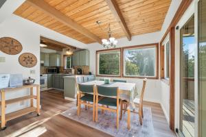 a kitchen and dining room with a table and chairs at After Dune Delight MCA#50643 in Manzanita