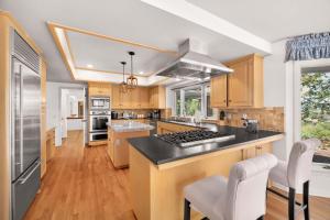 a kitchen with wooden cabinets and a black counter top at Spacious Villa Private Gameroom in Fallbrook