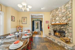 a dining room with a large stone fireplace at Bella Mar in Nehalem