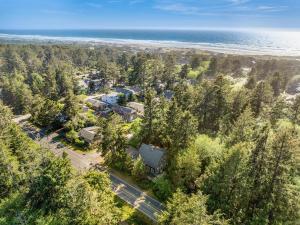 an aerial view of a house with trees and the beach at Bella Mar in Nehalem