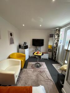 a living room with a couch and a tv at Self-Contained Studio with Ensuite & Private Access in Hardwicke