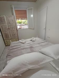 a large bed in a bedroom with a mirror at GIATRELOS HOUSE "near the shipwreck Zakynthos" in Volímai