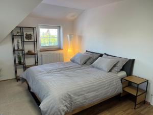 a large bed in a bedroom with a window at Vila SoHo in Vysoké Mýto