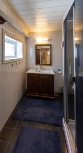 a bathroom with a sink and a mirror at Storgata 49 Appartements Svolvær in Svolvær +20 photos