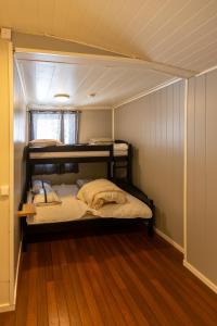 a room with three bunk beds in a house at Storgata 49 Appartements Svolvær in Svolvær
