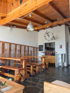 a large room with wooden tables and benches at Bariloche Hostel in San Carlos de Bariloche +41 photos
