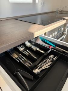 a drawer in a kitchen with utensils at Ferienwohnung Thomas in Oberau