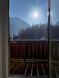 a window with a view of a snow covered mountain at Ferienwohnung Thomas in Oberau +9 photos