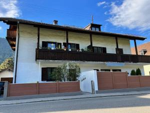 a house with a balcony on top of it at Ferienwohnung Thomas in Oberau