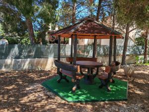a wooden table and chairs with a gazebo at Casa Vacanze Mari in San Vito lo Capo